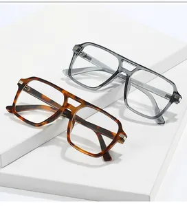 Close-up of stylish square frame glasses in tortoiseshell and smoky grey with metal accents