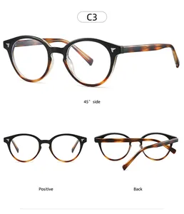 Detail view of round retro glasses with black and tortoise frames and silver wing accents