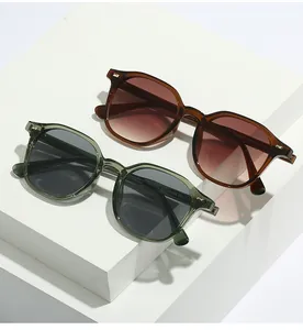 Detail of retro jelly-colored sunglasses with metal studs and CE marking on temples