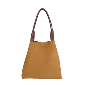 Minimalist ginger suede tote bag with brown handles in a large capacity trapezoid design