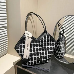 Plaid tweed tote bag with V-shaped opening and black leather handles for winter fashion