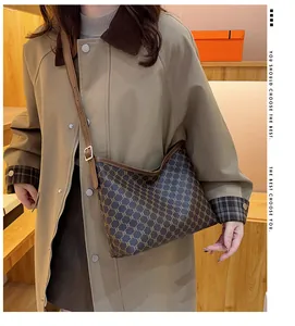 Retro monogram tote bag styled with a beige trench coat for a sophisticated vintage look