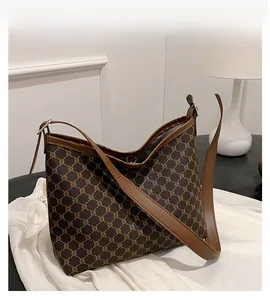 Detail of vintage monogram canvas tote bag with brown leather trim and metal buckle