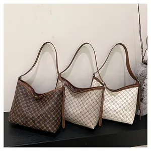 Three vintage hobo bags with geometric patterns and adjustable straps in three colors
