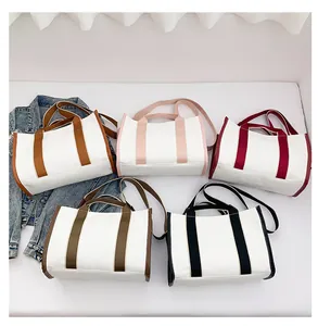 Flat lay of colorful striped canvas tote bags with shoulder straps in five colors
