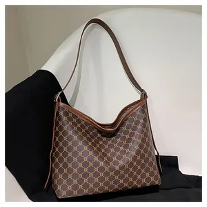 Macro detail of brown retro monogram canvas tote with premium leather edge trim