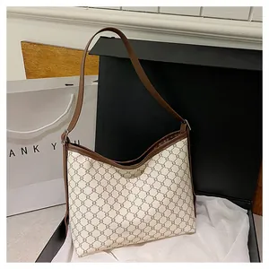 Macro detail of retro canvas tote featuring chain pattern and brown leather trim