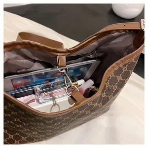 Top view of large tote bag interior showing spacious storage with laptop and cosmetics