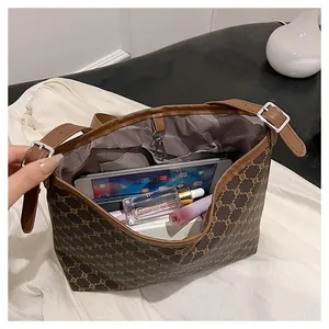 Detail view of large capacity vintage tote bag holding a tablet and cosmetics