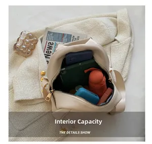 Internal capacity of beige leather backpack showing phone, tablet and folding umbrella