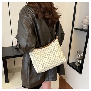 Detail of vintage geometric pattern shoulder bag with brown leather trim and slim strap