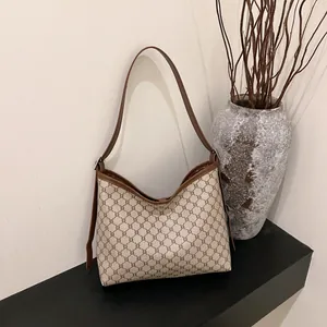 Retro monogram canvas tote bag with brown leather trim and handles for daily commute