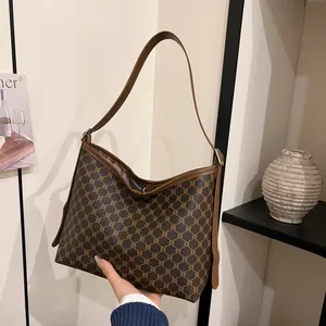 Vintage monogram tote bag with brown leather straps and classic retro aesthetic for women