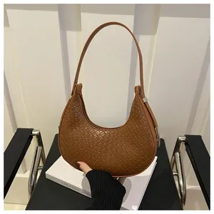 Brown woven crescent hobo bag with vintage texture and silver metallic hardware