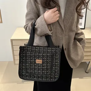 Large black and white plaid tweed tote bag with leather tag for daily commuting