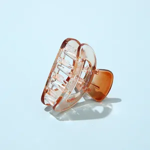 Close-up of amber translucent hair claw clip with durable metal spring and polished teeth