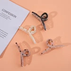 Detailed set of 13cm hair claw clips in four colors with stylish black polka dot pattern