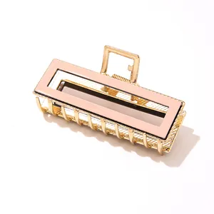 Elegant gold metal rectangular hair claw clip with a soft pink acetate inlay finish