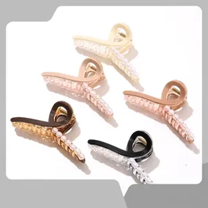 Detail showing five acrylic flower hair claws with rhinestone and pearl accents