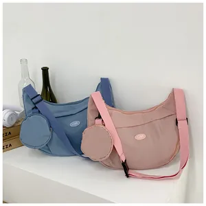Detail of pink and blue crescent crossbody bags with matching round coin pouches