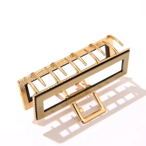 Close-up of a large gold rectangular metal hair claw clip with khaki resin inlay