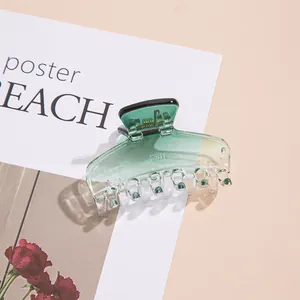 Translucent gradient green hair claw clip for elegant bun hairstyles on yellow background