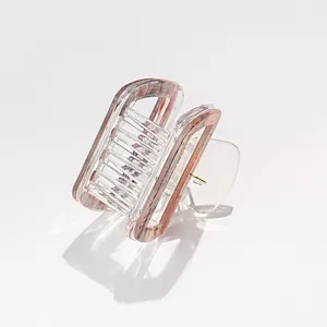 Detail of square acrylic hair claw clip with pink purple striped marble texture