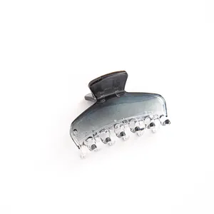 Transparent gradient hair claw clip in elegant black to clear resin for daily hairstyling