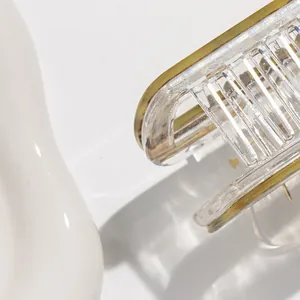 Detailed close-up of striped acrylic hair claw clip with tortoise shell texture and smooth teeth