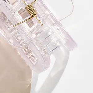 Close-up of translucent purple square hair claw clip with a strong gold metal spring