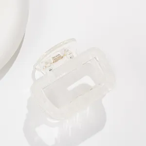 Detail of transparent square hair claw clip featuring a sturdy metal spring and hollow design