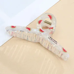 Close-up of a large iridescent acrylic hair claw clip with fresh watermelon pattern