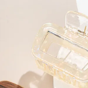 Elegant iridescent champagne square hair claw clip with translucent resin and metal spring