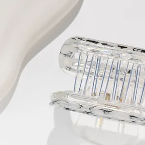 Macro shot of square hair claw clip with black marble patterns on transparent acrylic