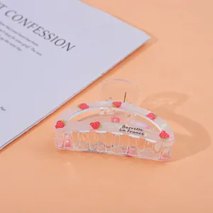 Detailed view of translucent strawberry pattern hair claw with French lettering