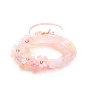 Elegant floral hair claw clip with pink gradient finish and sparkling rhinestones