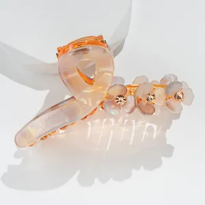 Detailed macro view of pearlescent flower hair claw clip with rhinestones