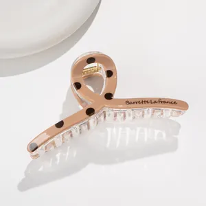 French retro polka dot hair claw clip in beige resin with black dots for hair styling