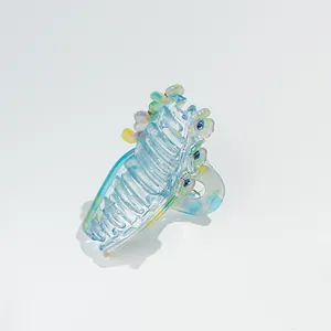 Close-up of marble blue hair claw clip with colorful resin flowers and crystals