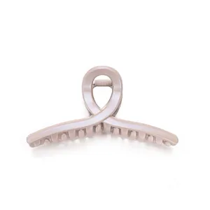 Elegant minimalist champagne gold glitter hair claw clip with crossed design for women