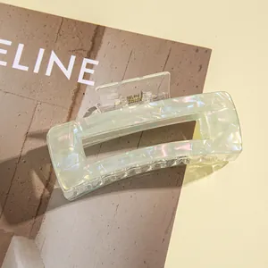 Detail shot of light green rectangular hair claw clip with pearlescent acetate texture