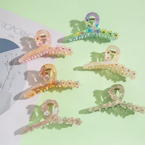 Plat de six pinces à cheveux colorées en acétate avec fleurs et strass sur fond vert