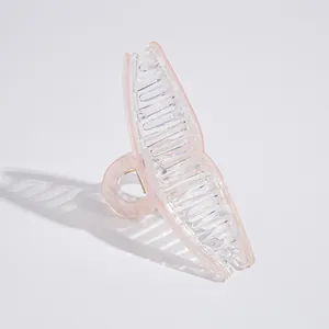 Detail view of large light pink translucent hair claw clip with strong resin teeth