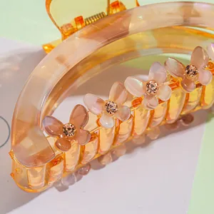 Pince à cheveux en acrylique ambré avec strass colorés et ornements papillons