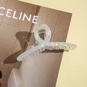 Close-up of holographic square hair claw clip with metallic spring for elegant styling