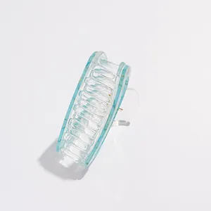 Detail of blue marble pattern acrylic hair claw clip with silver metal spring mechanism