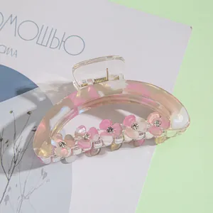 Detail of 9cm acrylic flower hair claw clip with rhinestones and marble texture