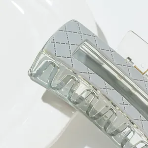 Modern light grey hair claw clip with checkered pattern and wavy transparent teeth