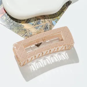 Close-up of a pink rectangular hair claw clip with elegant quilted texture and hollow design