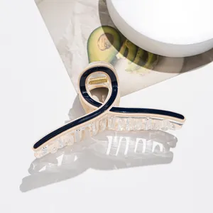Detail view of large acetate hair claw with navy swirls and strong metal spring